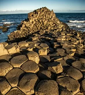 Images Dated 29th July 2016: The rising sun on a rock formation called the Giants Causeway, County Antrim, Northern Ireland