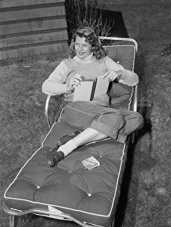 Nevada Prints: Rita Hayworth Relaxing on Lounge Chair with Book