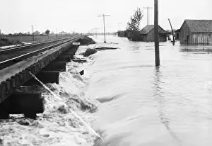 Flood Prints: River Flood Waters Wash Around Rr Trestl