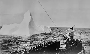 Prints of An American flag flies from the revenue cutter Modoc during an anniversary service for the sinking of the British ocean liner Titanic, an iceberg in the background, in the North Atlantic A Visual Journey Through the Legacy of the World’s Most Infamous Ship: RMS Titanic Anniversary Service, 1927