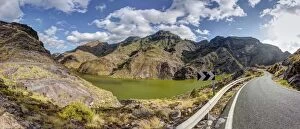 Road at the Embalse Presa del Parralillo reservoir, also called the green lake, in the mountains of Caldera de Tejeda
