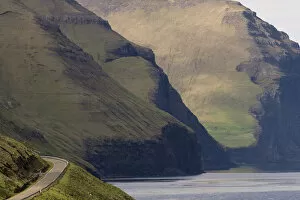 Road and mountains towering from the sea, Kalsoy, Norooyar, Faroe Islands, Denmark