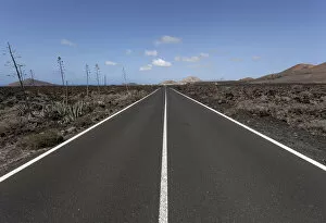 Road through volcanic landscape, near Mancha Blanca, Lanzarote, Canary Islands, Spain