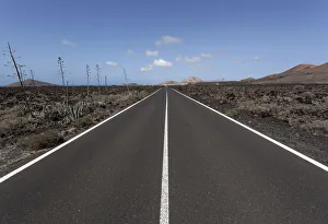 Images Dated 8th August 2012: Road through volcanic landscape, near Mancha Blanca, Lanzarote, Canary Islands, Spain