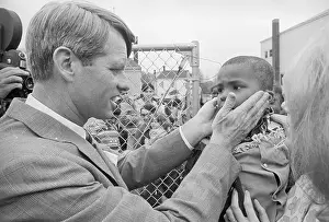 Robert F. Kennedy Embracing Face of Youngster