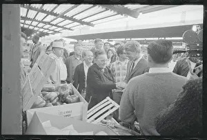 Robert F. Kennedy Near Market Display With Followers