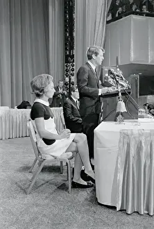 Robert F. Kennedy at Podium With Wife Sitting Nearby