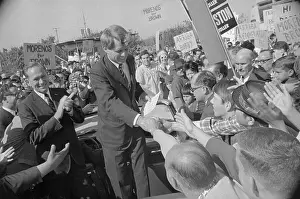 Robert F. Kennedy Reaching Down to Shake Hands of Onlookers
