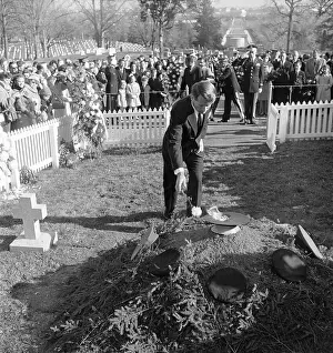 Robert F. Kennedy Stooping to Place Single Flower on Grave