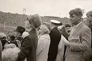 Robert F. Kennedy Watching Football Game and Holding Sports Literature