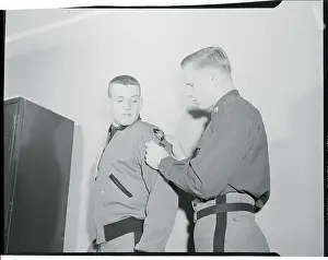 Robert Ferris Helping Pete Vann with Shoulder Patch