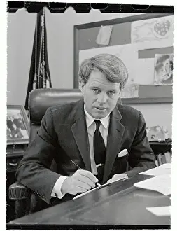 Robert Francis Kennedy Pausing from Writing at His Desk