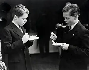 Teenage Boy Prints: Robert Kennedy and friend eating from a bowl