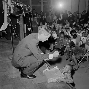 Robert Kennedy Giving a Present to a Young Boy
