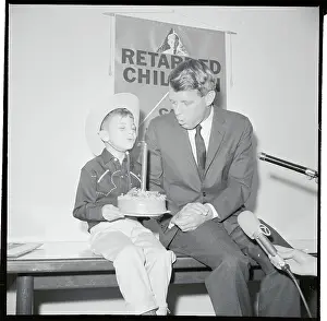 Robert Kennedy and A Young Boy Blowing Out a Candle