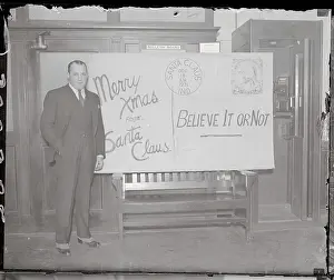 Ripley Prints: Robert L. Ripley Posing by Large Card