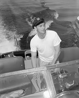 Prints of (Original Caption) 1950-Las Vegas, NV- Recovering from recent Hollywood ordeal, actor Robert Mitchum takes a long-planned vacation at Lake Mead behind Hoover (Boulder) A Timeless Collection of Hoover Dam Photography: Robert Mitchum Driving a Motorboat
