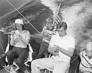 Prints of (Original Caption) 1949-Las Vegas, NV- Recovering from a recent Hollywood ordeal, actor Robert Mitchum takes his family on a fishing vacation at famed Lake Mead A Timeless Collection of Hoover Dam Photography: Robert Mitchum and Family Fishing on Lake Mead