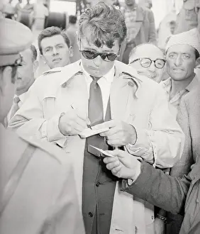Genoa Prints: Robert Mitchum Signing Autographs