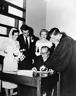 Prints of American actors Natalie Wood (1938 - 1981) and Robert Wagner watch a priest show an unidentified man where to sign a book on their wedding day, Scottsdale, Arizona, December 28, 1957 Grace, Glamour & Timeless Elegance: Robert Wagner & Natalie Wood Wedding