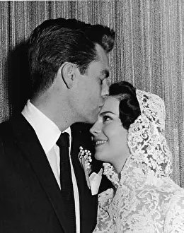 Prints of American actor Robert Wagner kisses the forehead of his bride, American actress Natalie Wood (1938-1981), at their wedding ceremony, Scottsdale, Arizona, December 28, 1957 Grace, Glamour & Timeless Elegance: Robert Wagner & Natalie Wood Wedding