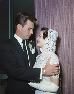 Prints of American actor Robert Wagner, wearing a suit and tie with a corsage, and American actor Natalie Wood (1938 - 1981), wearing a white strapless wedding dress with a white lace hooded cape Grace, Glamour & Timeless Elegance: Robert Wagner & Natalie Wood Wedding