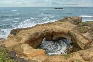 Rock arch and headland in distance, Devils Punchbowl State Natural Area, Oregon, USA