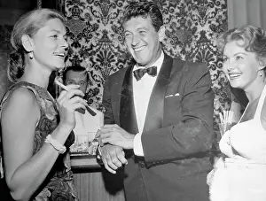 Prints of (Original Caption). Rock Hudson, flanked by Lauren Bacall and Rhonda Fleming, seems to be enjoying himself The Essence of Cool: Rock Hudson with Lauren Bacall and Rhonda Fleming
