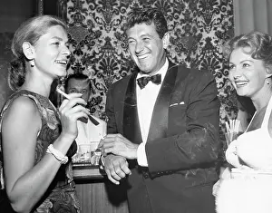 Prints of (Original Caption). Rock Hudson, flanked by Lauren Bacall and Rhonda Fleming, seems to be enjoying himself The Essence of Cool: Rock Hudson with Lauren Bacall and Rhonda Fleming