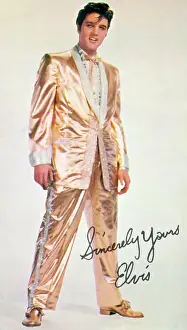 Rock and roll musician Elvis Presley in his gold suit