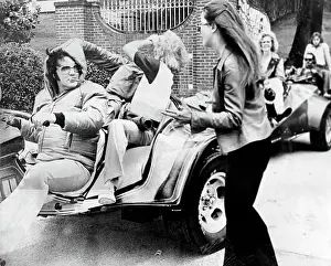 Rock and roll singer Elvis Presley leads a caravan of 3-wheelers