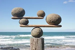 Images Dated 16th April 2016: Rocks balancing on driftwood, sea in background