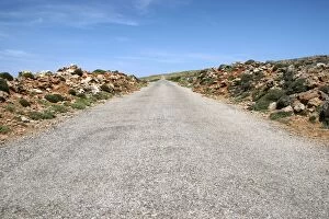 Images Dated 6th June 2012: Rocks lining a straight country road at Cap de Cavalleria, Cap de Cavalleria, Menorca