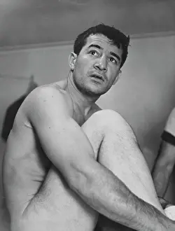 Prints of American boxer Rocky Graziano (1919-1990) sits naked after his middleweight championship fight was cancelled after he broke his thumb, at Greenwood Lake, New York, 13th June 1950 In the Ring: The Art of Boxing: Rocky Graziano, American Boxer