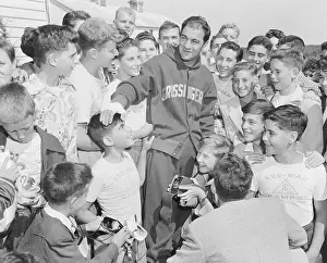 Grossinger Prints: Rocky Marciano at Center of Attentive Fans