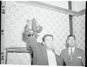 Rocky Marciano Holding Up His Boxing Gloves