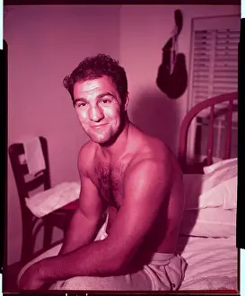 Rocky Marciano Sitting on Bed