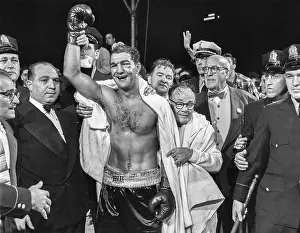 Prints of PHILADELPHIA, PA - SEPTEMBER 23: The winner and new World Heavyweight Champion Rocky Marciano by virtue of a 13th round knockout poses for a portrait In the Ring: The Art of Boxing: Rocky Marciano v Jersey Joe Walcott