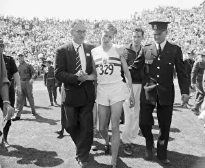 Vancouver Prints: Roger Bannister Being Helped Off Racetrack