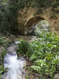 Roman bridge into a ravine in a mountain stream