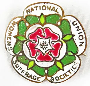 Prints of Red, green, and white, multi-lobed enamel pin or badge, with a stylized five-petalled red rose and the text National Union Women Suffrage Societies Historic Moments from the Women’s Fight for the Vote: Rose Suffrage Pin