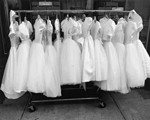 Henri Silberman Collection Gallery: Row of white dresses hanging on rack