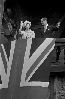 Prints of WEST BERLIN, FRG - MAY 28: Queen Elizabeth II and Prince Philip, Duke of Edinburgh wave to the crowds from a bacony behind a draped Union Jack flag on May 28, 1965 in West Berlin, West Germany Queen Elizabeth II Prints: Royal Visit To West Germany