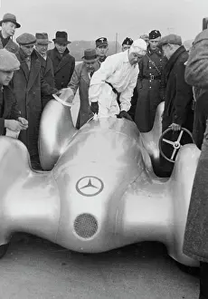 Prints of German racing driver Rudolf Caracciola with a Mercedes W154 3-Litre race car at the Dessauer Rennstrecke (Dessau race track) in Dessau, Saxony-Anhalt, Germany, 9th February 1939 Legends of the Track: Rudolf Caracciola's Mercedes W154 Race Car