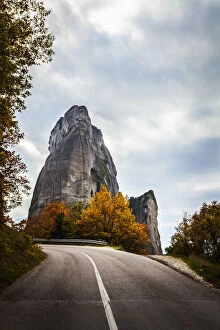 Rugged cliffs, road and autumn foliage