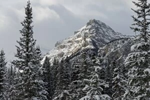 Lake Louise, Canada Gallery: Rugged mountain peak with snow under a cloudy sky