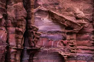 A rugged rock wall of colourful sandstone