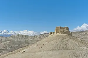 Ruins of the Ketcher Dzong fortress, the Annapurna Range at back, near Lo Manthang, Upper Mustang, Lo, Nepal