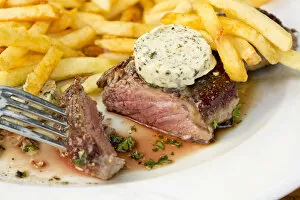 Rump steak, medium, with French fries and herb butter