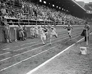 Relay Racer Prints: Runners Crossing Finish Line in College Relay Championship